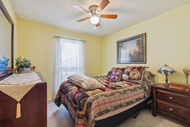 carpeted bedroom with ceiling fan and a textured ceiling