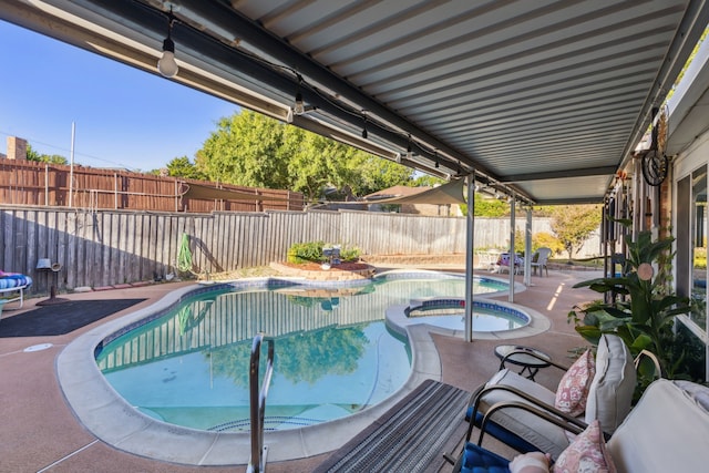 view of swimming pool with an in ground hot tub