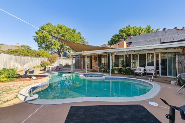 view of swimming pool featuring a patio area and an in ground hot tub