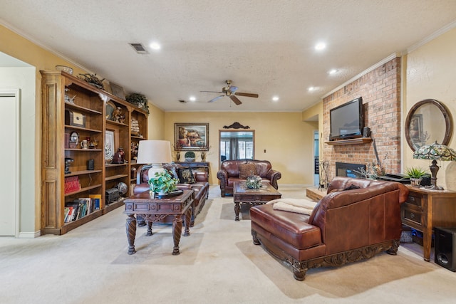 carpeted living room with a textured ceiling, a brick fireplace, ceiling fan, and crown molding