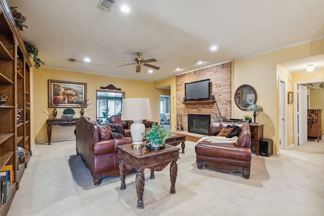 carpeted living room featuring a fireplace, ceiling fan, crown molding, and a textured ceiling