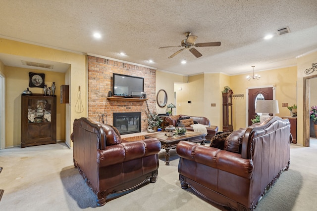 carpeted living room featuring ceiling fan with notable chandelier, a textured ceiling, a brick fireplace, and ornamental molding