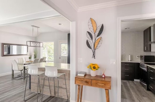 interior space with wood-type flooring and crown molding