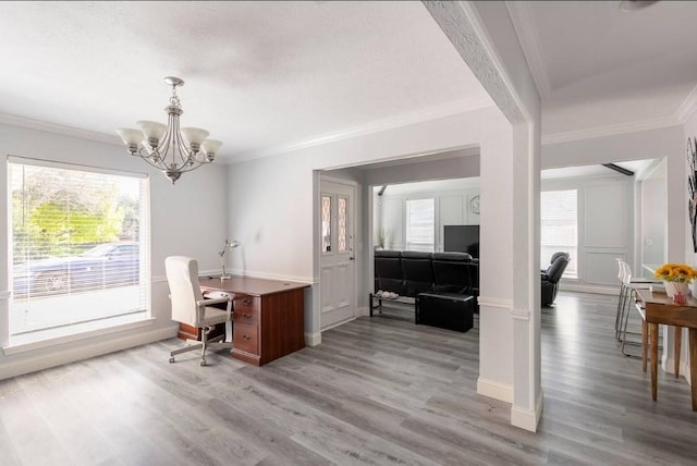 home office featuring ornamental molding, a notable chandelier, and light wood-type flooring