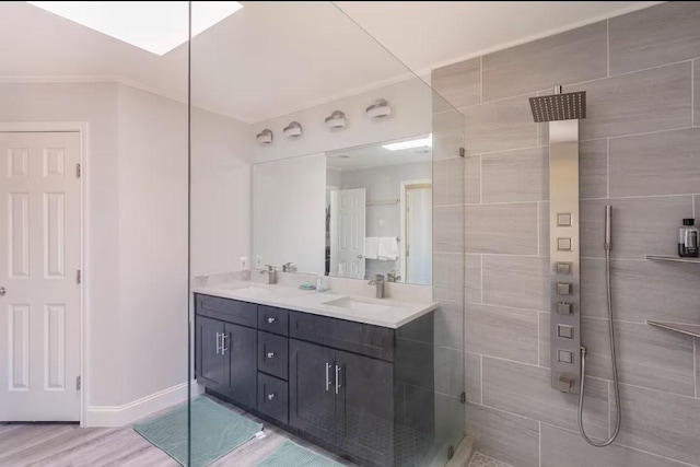 bathroom with a shower, hardwood / wood-style floors, and vanity