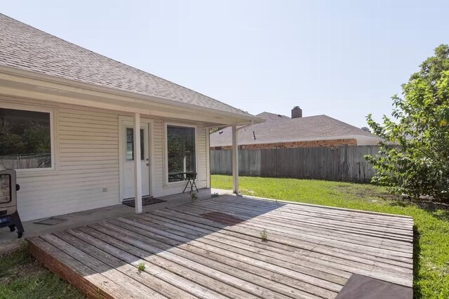 wooden deck with a lawn