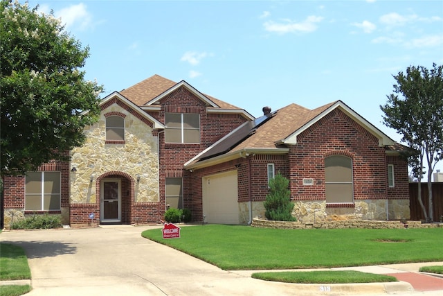 313 Hidden Lake Ct, Burleson, TX 76028 - view of front of home with concrete driveway, a garage, brick siding, a front yard, and stone siding