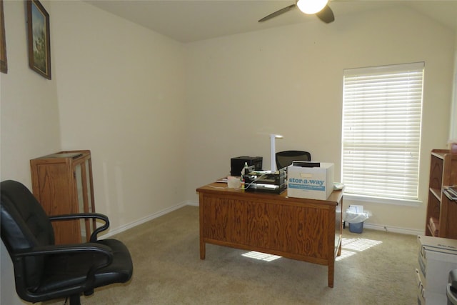carpeted office space with lofted ceiling, ceiling fan, and baseboards