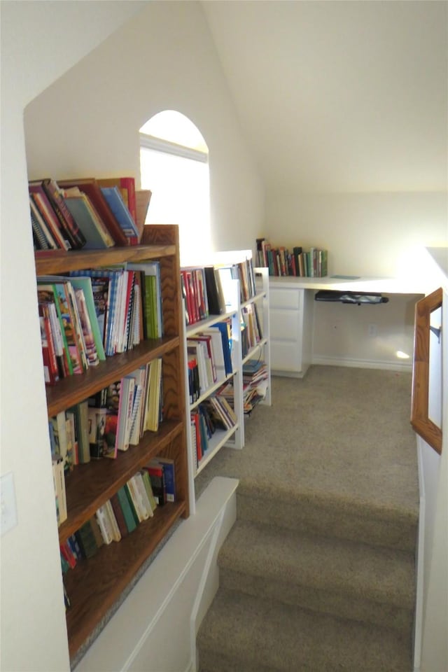 staircase with carpet and lofted ceiling