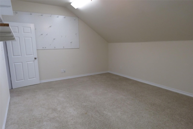 bonus room with carpet flooring, lofted ceiling, and baseboards