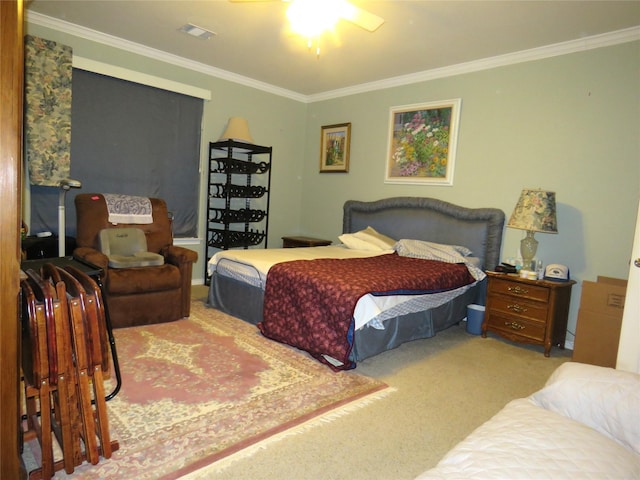 bedroom featuring ceiling fan, ornamental molding, and carpet flooring