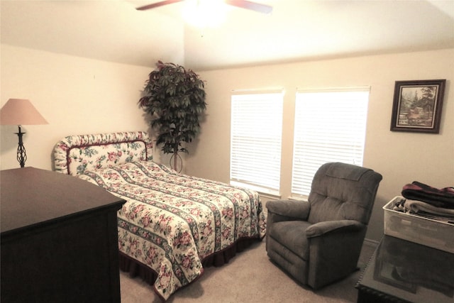 carpeted bedroom with a ceiling fan and vaulted ceiling