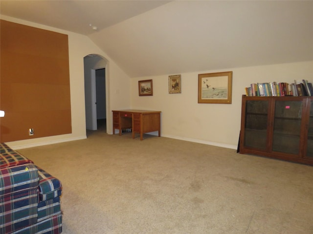 interior space with vaulted ceiling and carpet floors