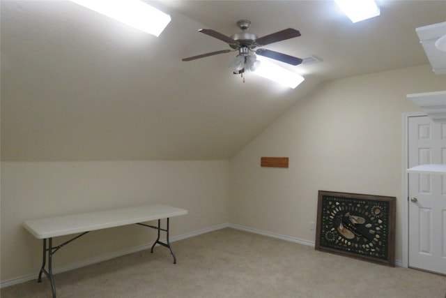 additional living space featuring lofted ceiling, light colored carpet, and ceiling fan