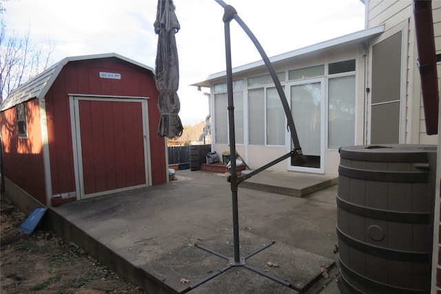 view of patio / terrace with an outdoor structure and a storage shed