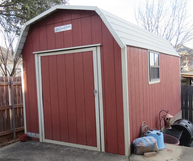 view of shed featuring fence
