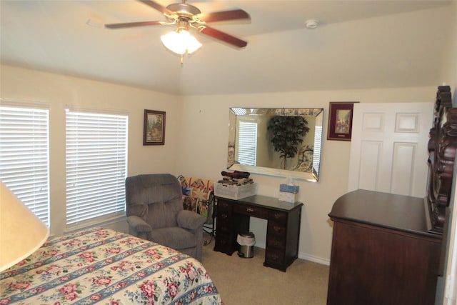 bedroom with lofted ceiling, light colored carpet, and ceiling fan