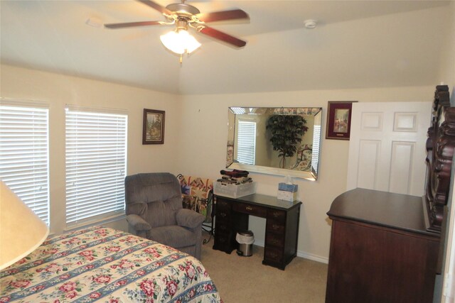 carpeted bedroom featuring multiple windows and ceiling fan