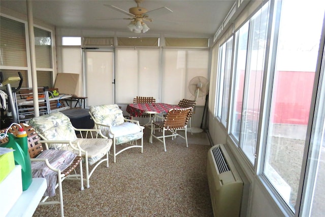 sunroom with an AC wall unit and ceiling fan