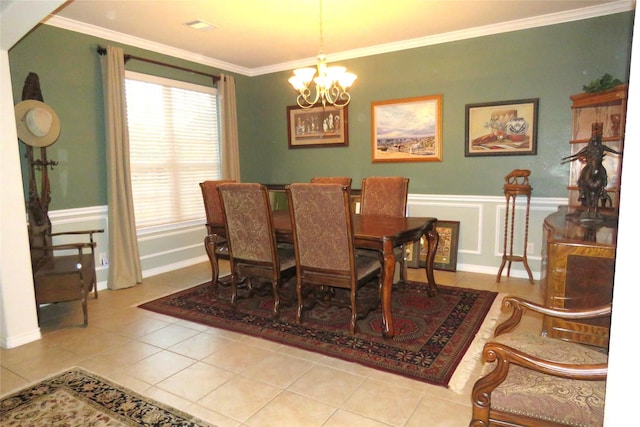 tiled dining area with crown molding and a notable chandelier