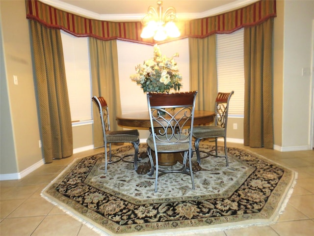 tiled dining area featuring crown molding and an inviting chandelier