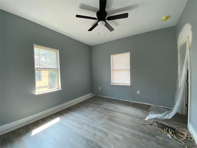 spare room featuring hardwood / wood-style flooring and ceiling fan