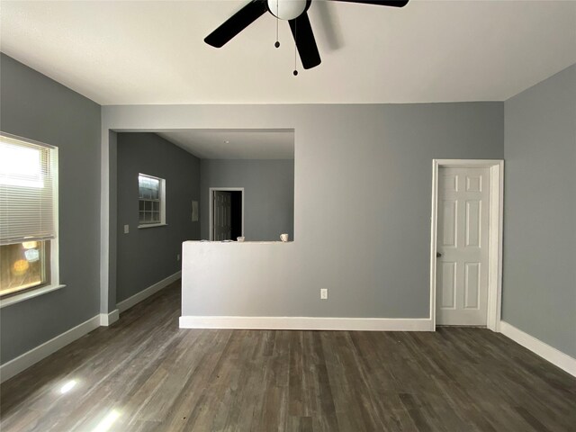 unfurnished room featuring ceiling fan and dark hardwood / wood-style flooring