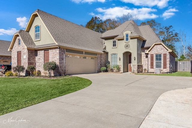 french provincial home with a garage and a front lawn