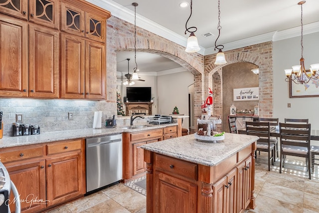 kitchen with sink, hanging light fixtures, dishwasher, a kitchen island, and ceiling fan with notable chandelier