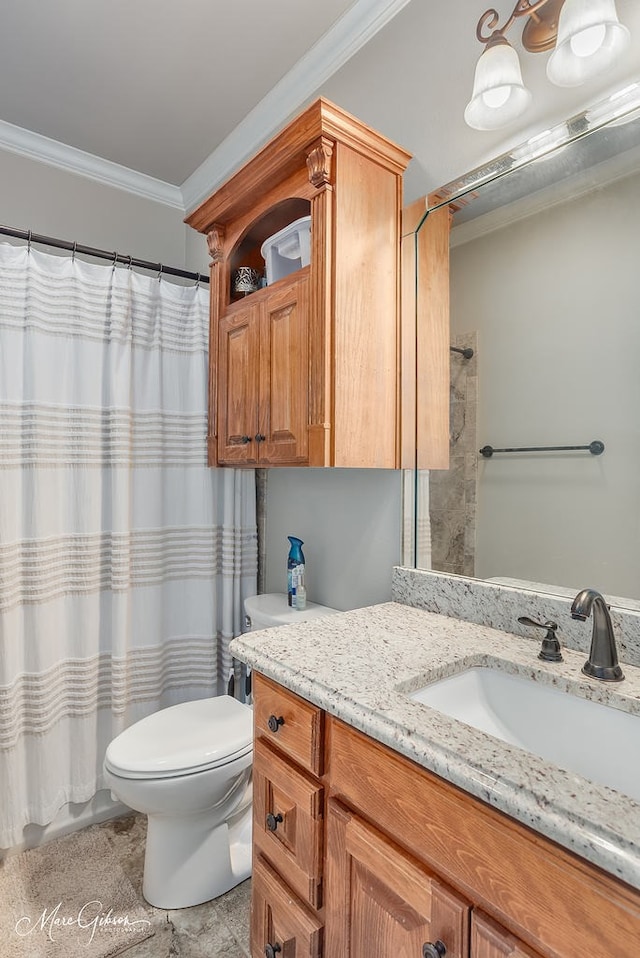 bathroom with vanity, ornamental molding, and toilet