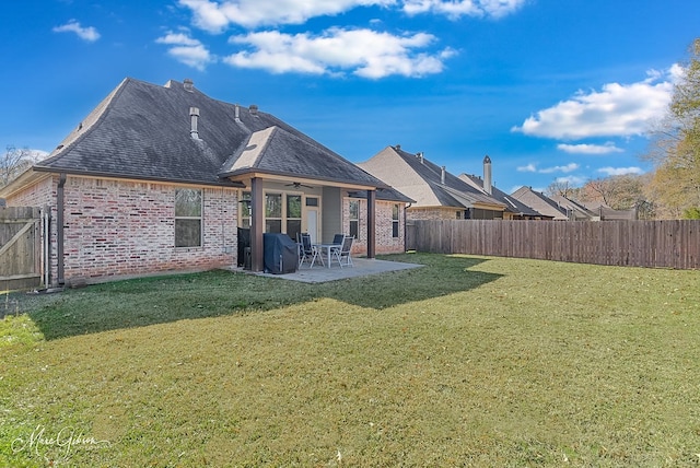 back of property featuring a patio area, ceiling fan, and a lawn