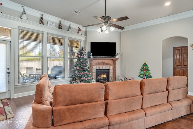 living room with ornamental molding, dark hardwood / wood-style floors, and ceiling fan