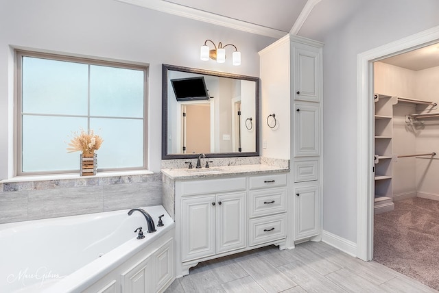 bathroom with a bathing tub, vanity, and hardwood / wood-style floors