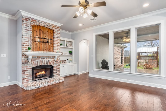 unfurnished living room featuring hardwood / wood-style flooring, crown molding, and a fireplace