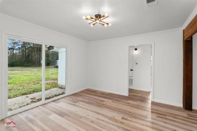 empty room with ornamental molding, a chandelier, and light hardwood / wood-style flooring