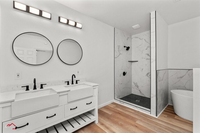 bathroom featuring vanity, independent shower and bath, hardwood / wood-style floors, and tile walls