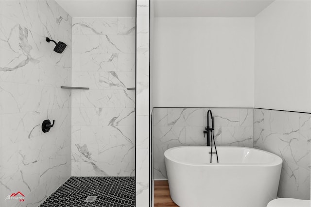 bathroom featuring tile walls and plus walk in shower