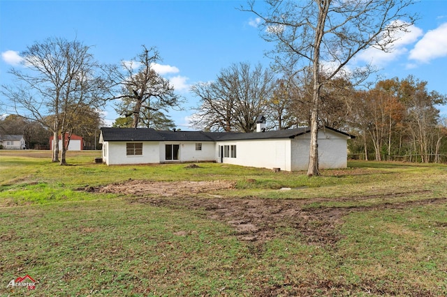 rear view of property featuring a yard