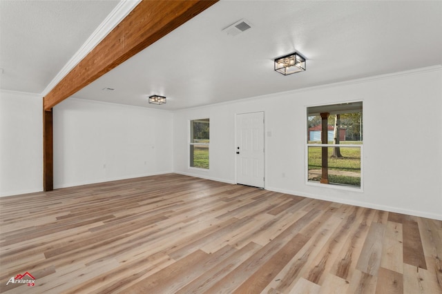 unfurnished living room with beam ceiling, light hardwood / wood-style floors, and crown molding