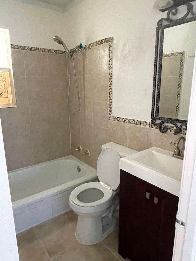 full bathroom with tile patterned flooring, vanity, toilet, and tiled shower / bath