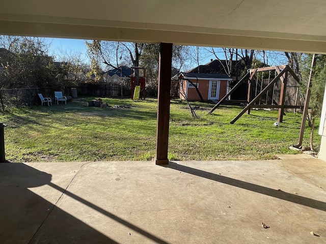 view of yard with a patio, a playground, and a shed