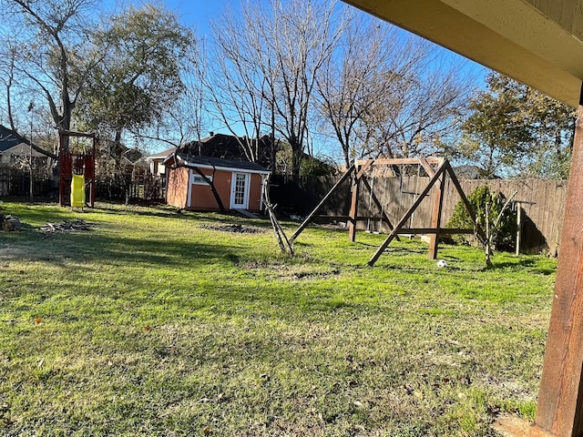 view of yard featuring a playground and a shed