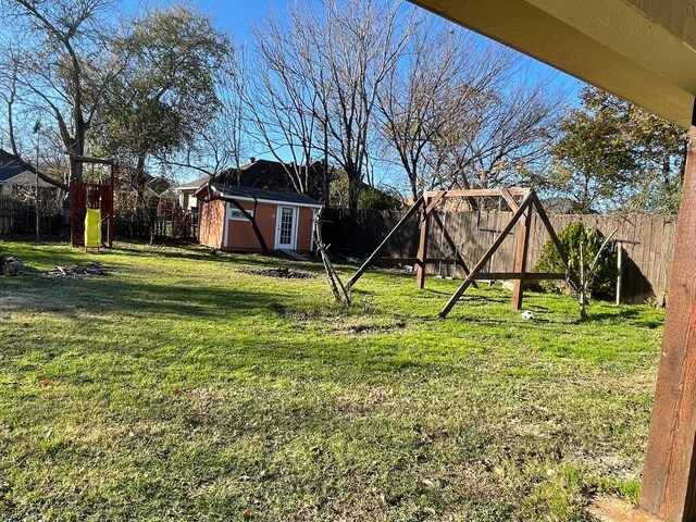 view of yard featuring a playground and a shed