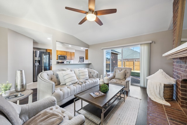 living room featuring light hardwood / wood-style floors, ceiling fan, and lofted ceiling