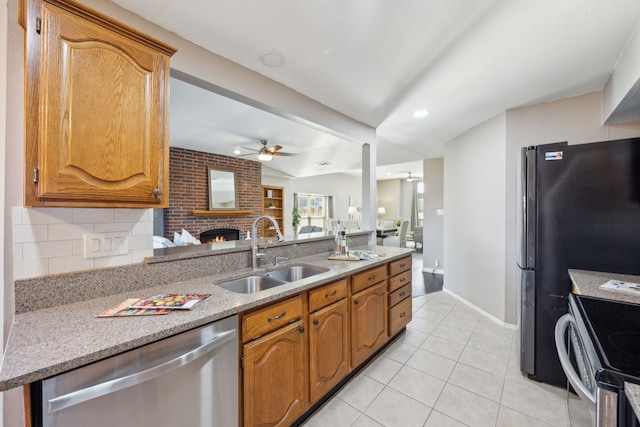 kitchen featuring ceiling fan, sink, tasteful backsplash, light tile patterned floors, and appliances with stainless steel finishes