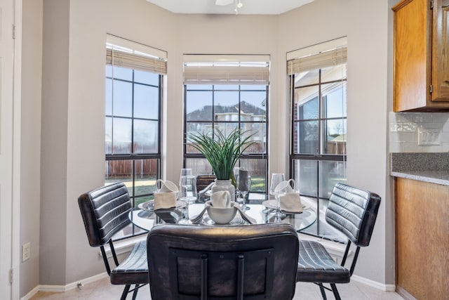 dining area with ceiling fan, a healthy amount of sunlight, and light tile patterned floors