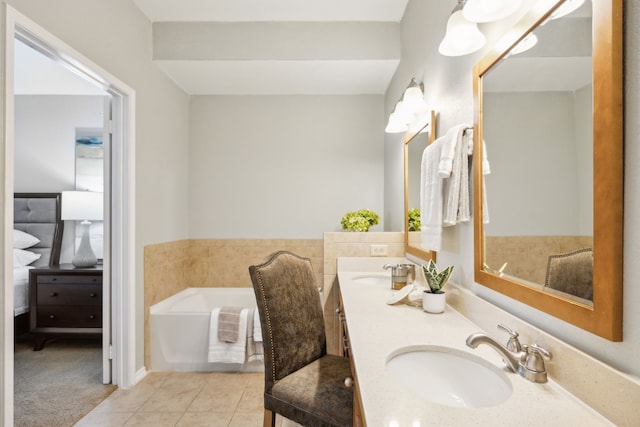 bathroom with tile patterned floors, vanity, and a tub to relax in