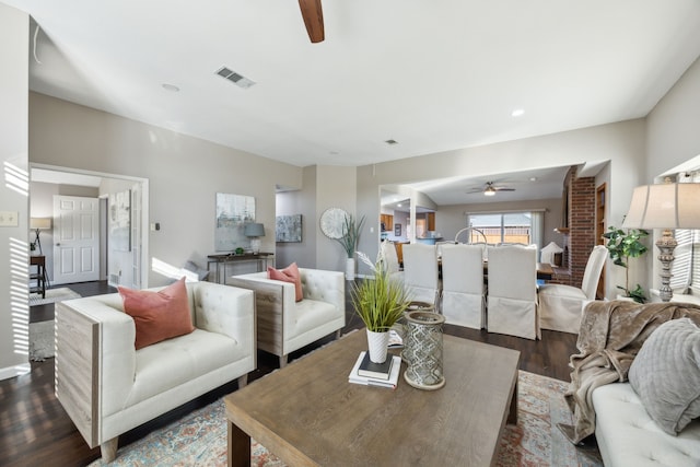 living room with ceiling fan and dark hardwood / wood-style flooring