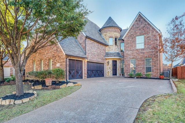 view of front of house with central AC unit and a garage