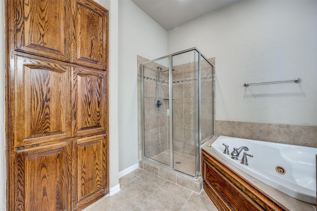 bathroom with tile patterned flooring and separate shower and tub